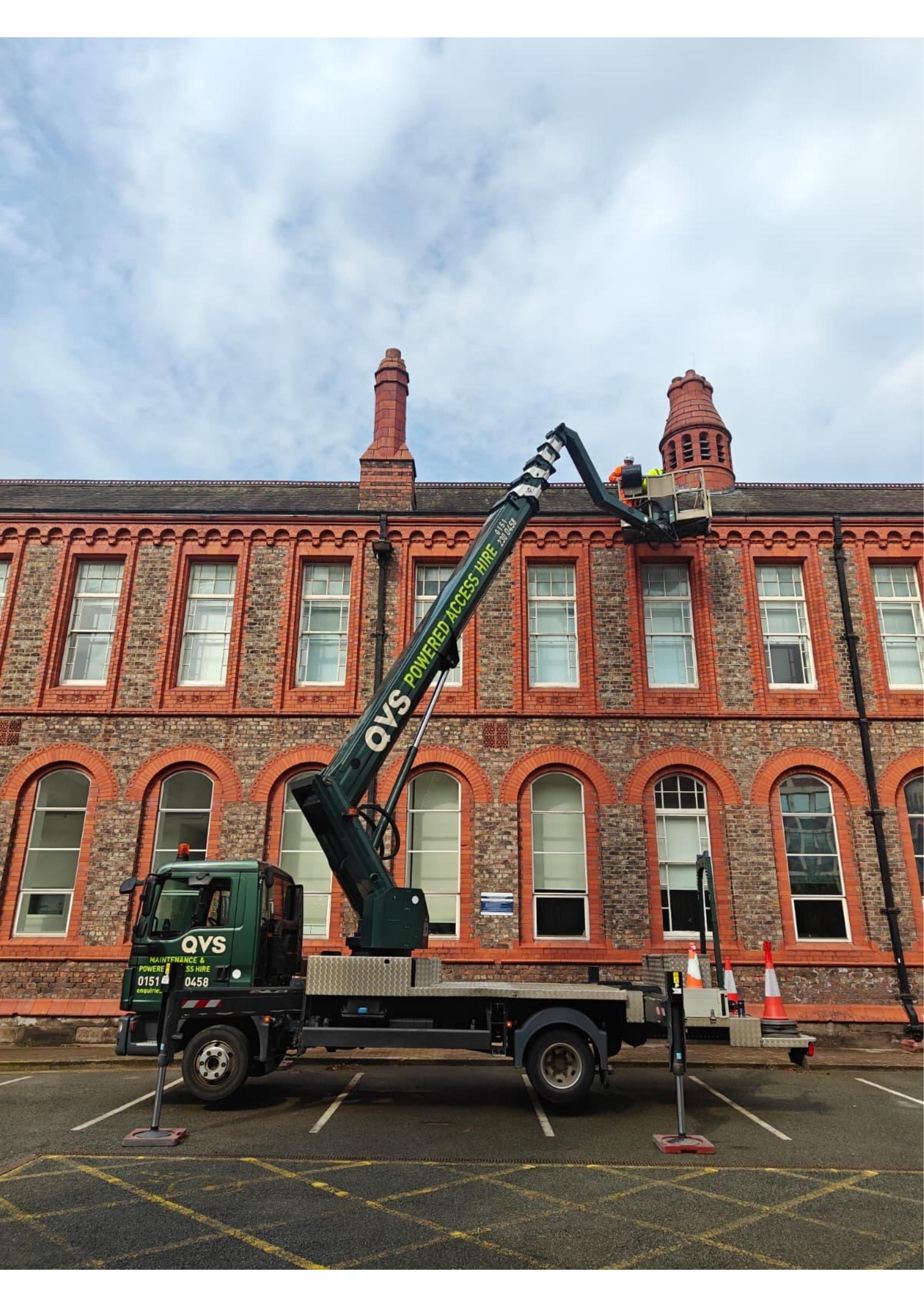QVS Powered Access cherry picker working at height on a building
